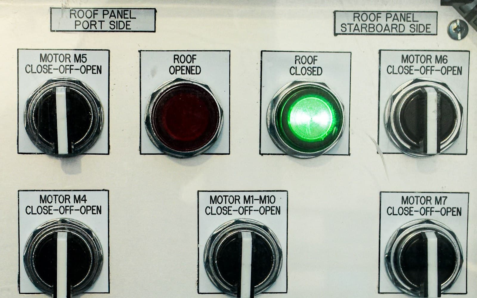 Industrial automation control panel with labeled motor switches and status indicators