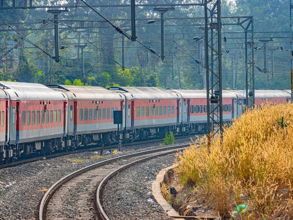 Indian Railways passenger train on electrified tracks
