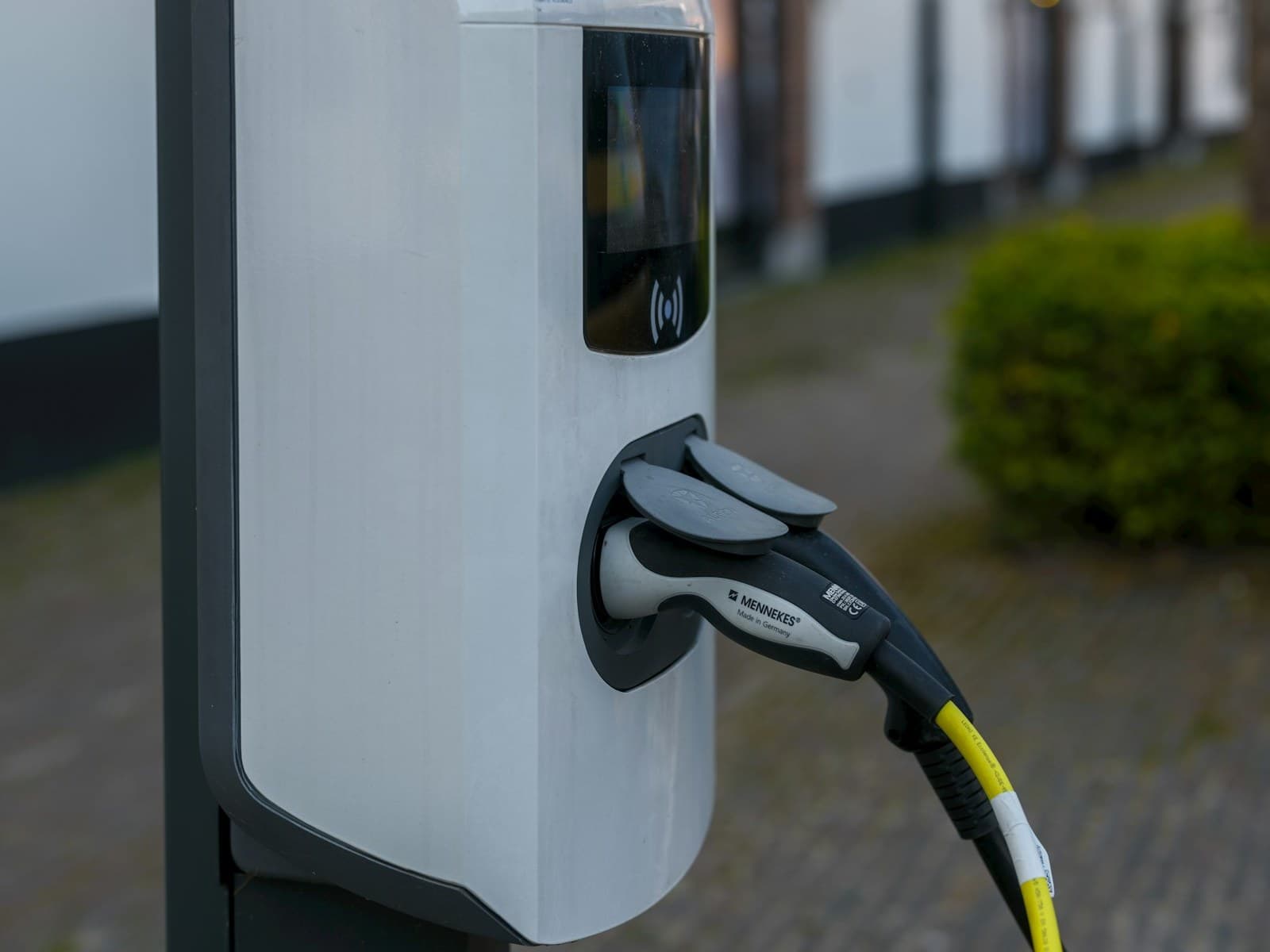 Electric vehicle charging station with connector plugged in